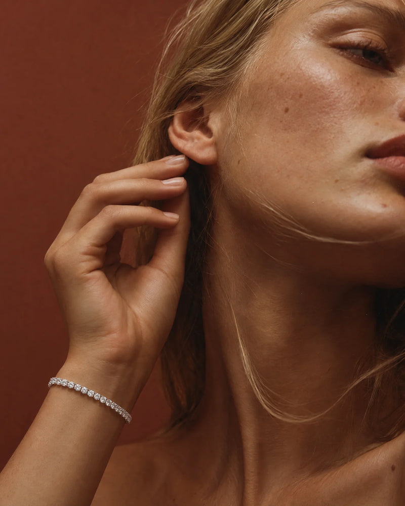 Bracelets: 4 carat lab-grown diamond tennis bracelet in 14K white gold worn on the wrist — AI-generated image — DEEVE