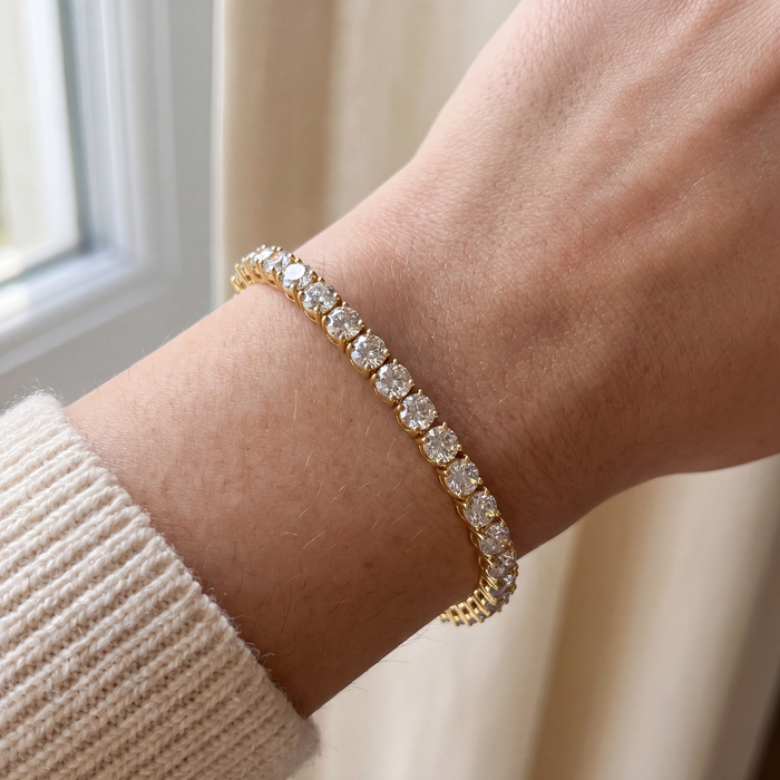 Close-up of a 10 carat lab-grown diamond tennis bracelet in 14K yellow gold worn on the wrist, AI-generated image — DEEVE