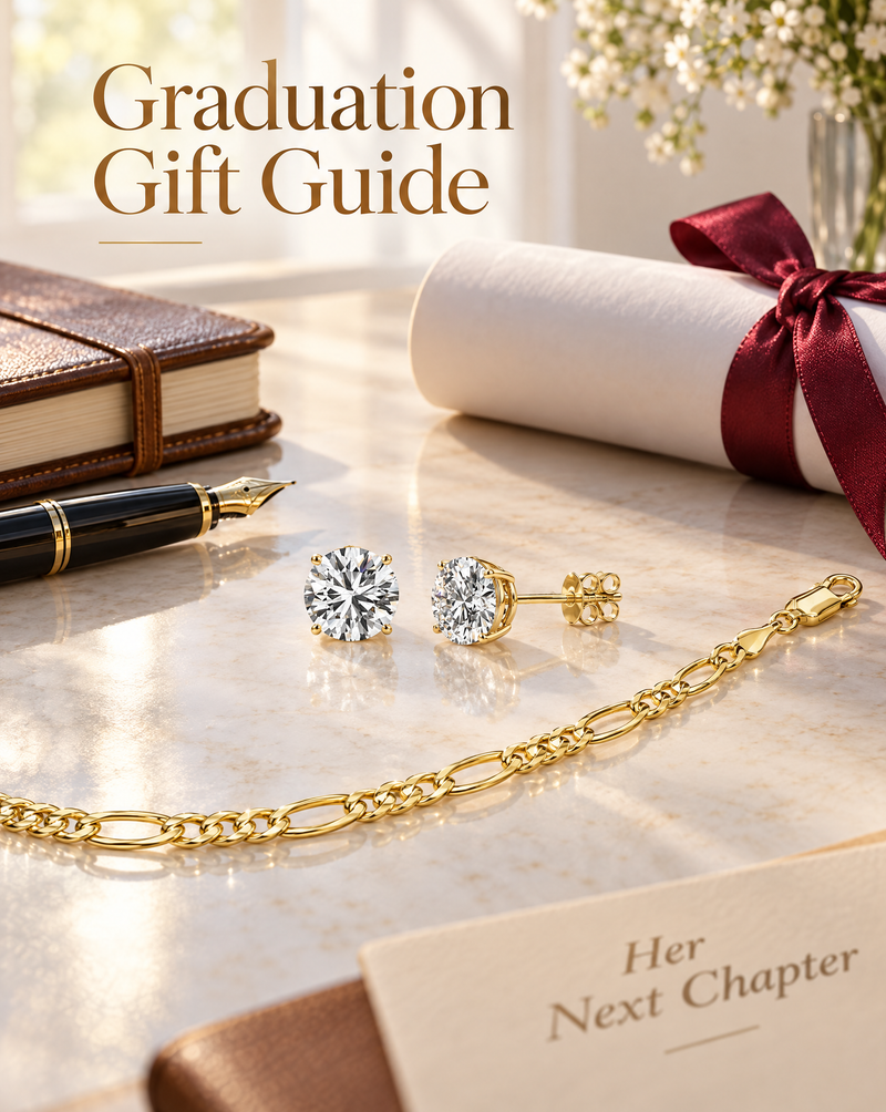 Round diamond stud earrings and a yellow gold Figaro chain on a desk with a diploma, a leather notebook and a fountain pen, under the words Graduation Gift Guide