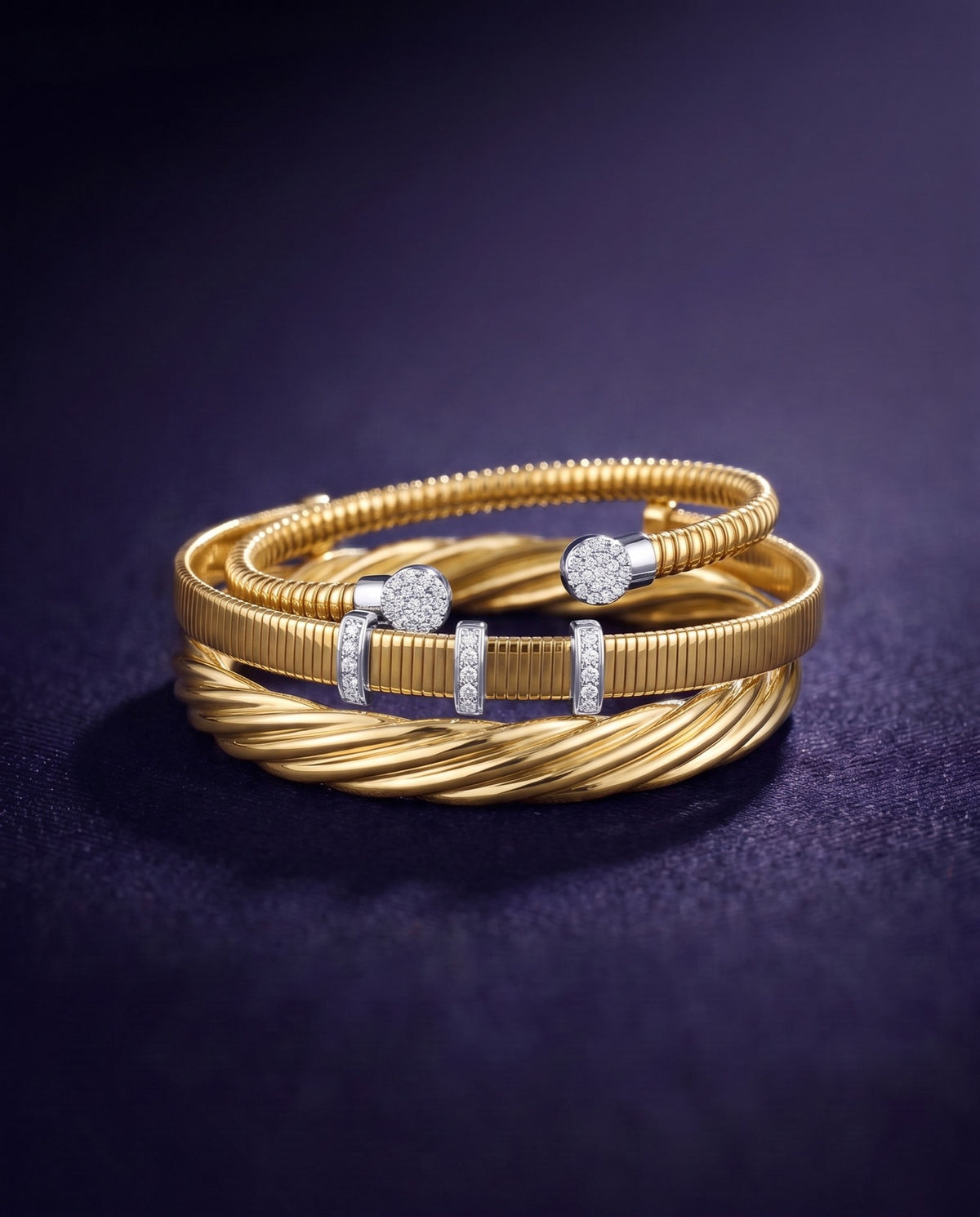 Twist bangle, tubogas cuff and diamond station cuff in 14K yellow gold