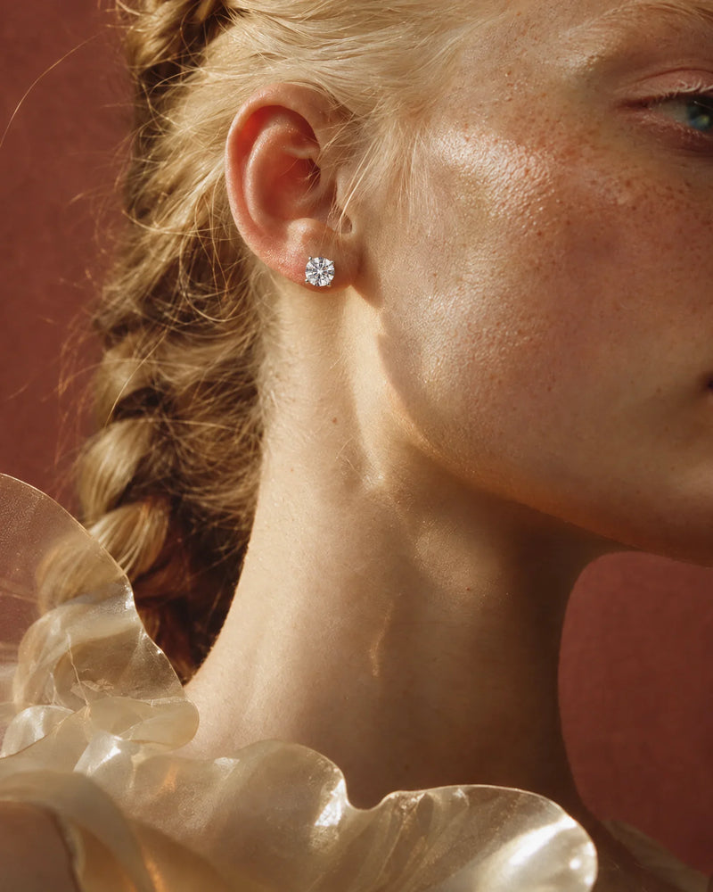 Diamond studs: 2 carat lab-grown diamond stud earrings in 14K white gold worn on the ear — AI-generated image — DEEVE