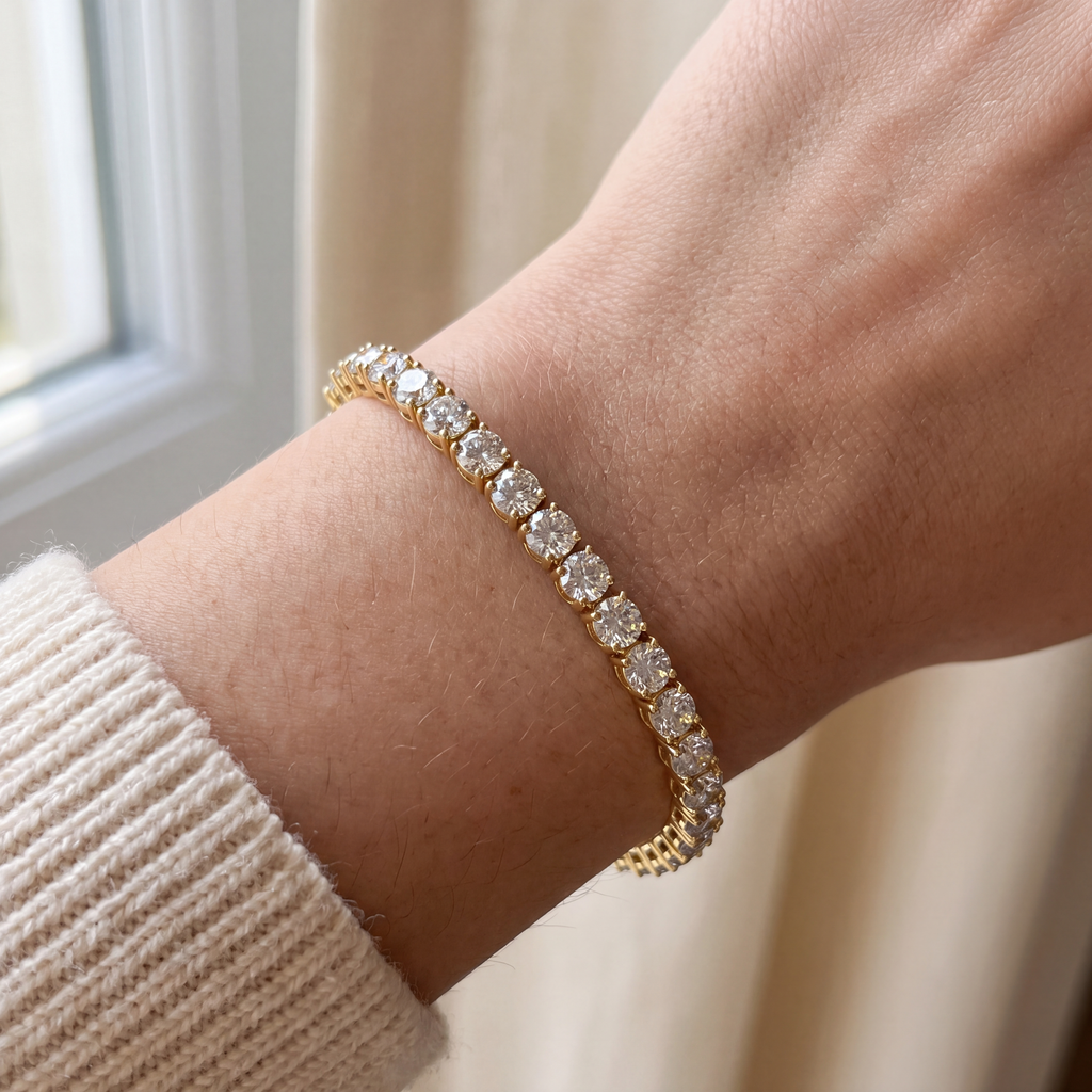 Close-up of a 10 carat lab-grown diamond tennis bracelet in 14K yellow gold worn on the wrist, AI-generated image — DEEVE