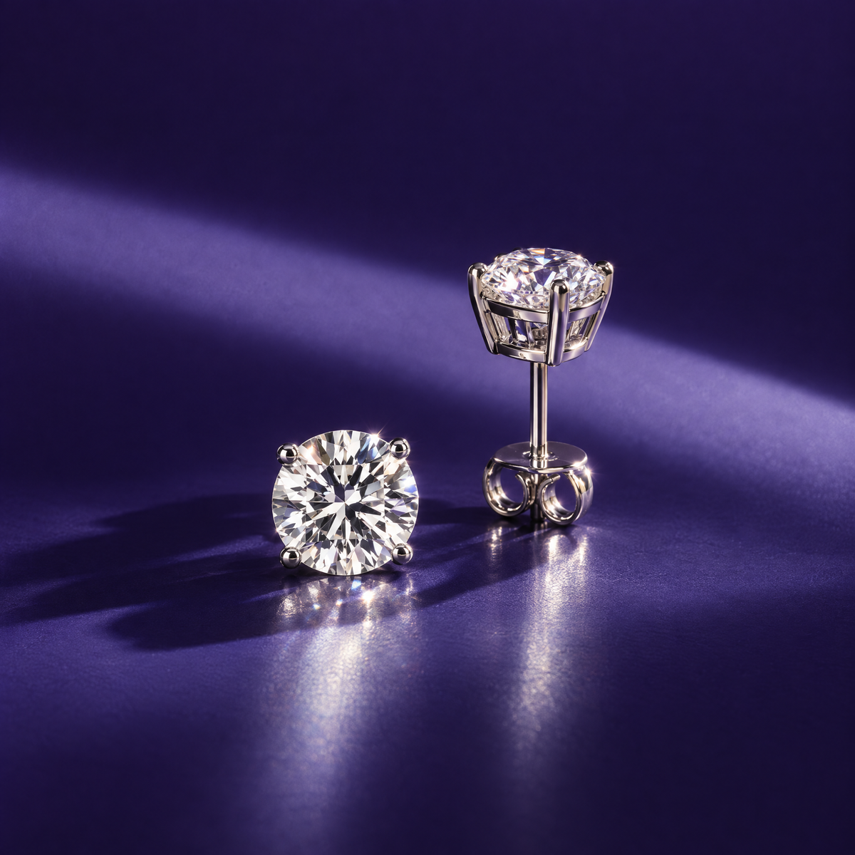 Pair of 2 carat round lab-grown diamond stud earrings in 14K white gold, four-prong settings, indigo background, AI-generated image — DEEVE