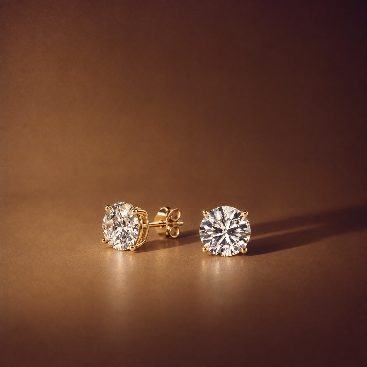 Pair of 3 carat round lab-grown diamond stud earrings in 14K yellow gold, one shown side-on with its four-prong basket, post and push back, brown background, AI-generated image — DEEVE