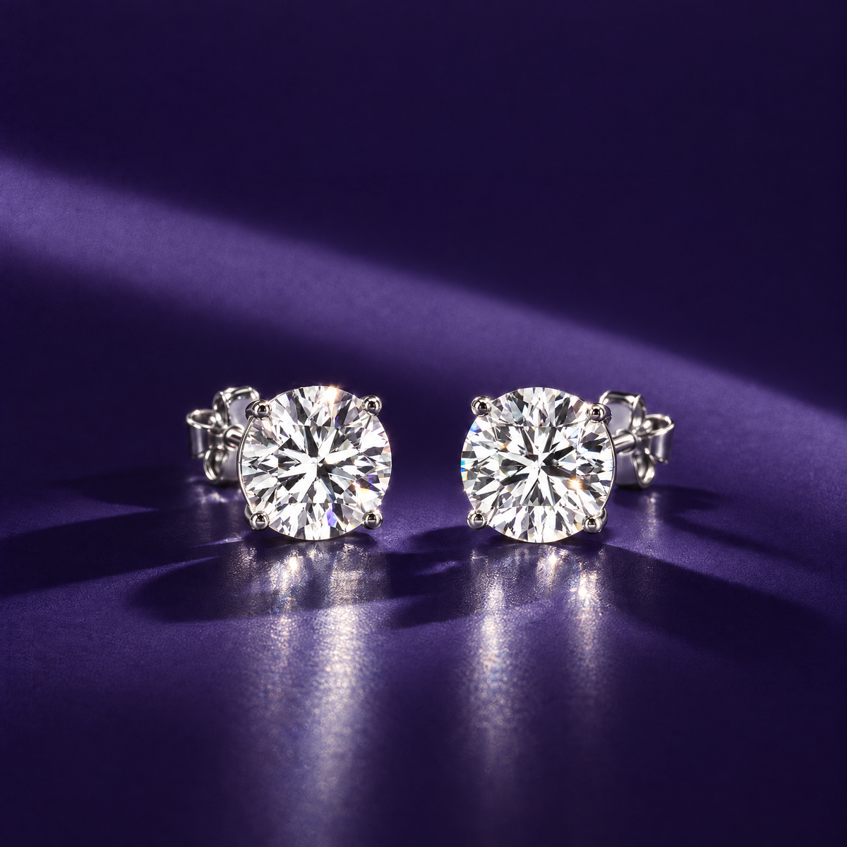 Pair of 4 carat round lab-grown diamond stud earrings in 14K white gold, four-prong settings, indigo background, AI-generated image — DEEVE