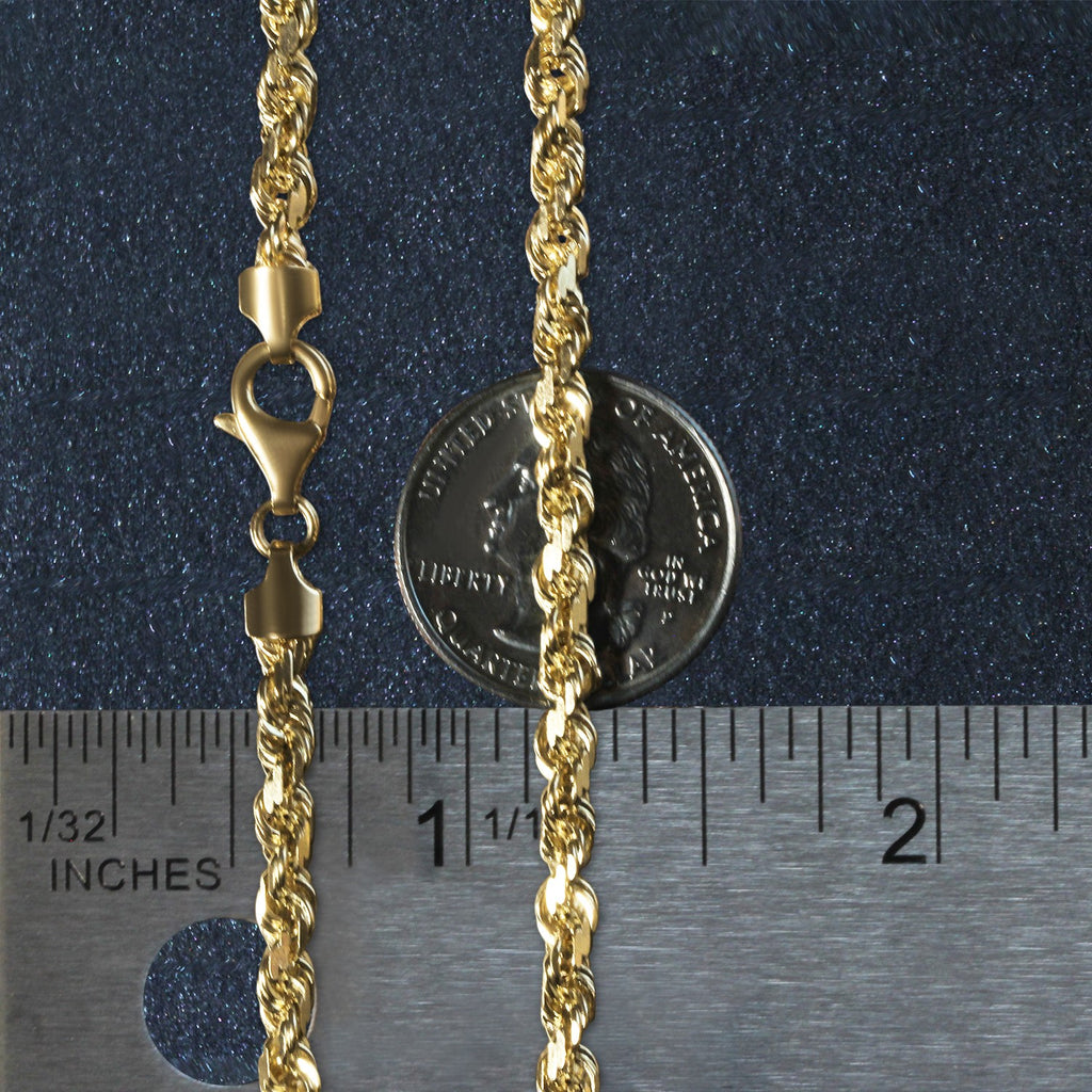 5.00mm rope chain in 14K yellow gold beside an inch ruler and a coin for scale