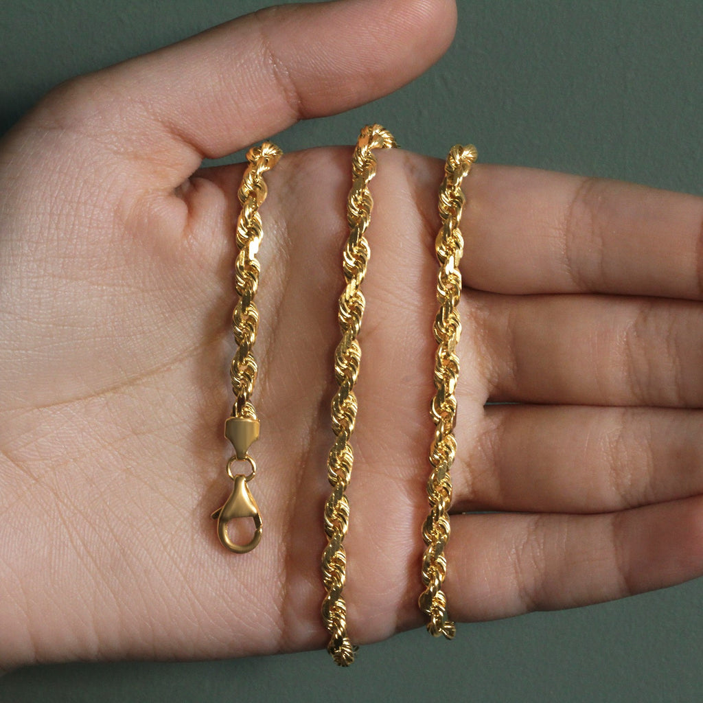 5.00mm rope chain in 14K yellow gold held across an open palm