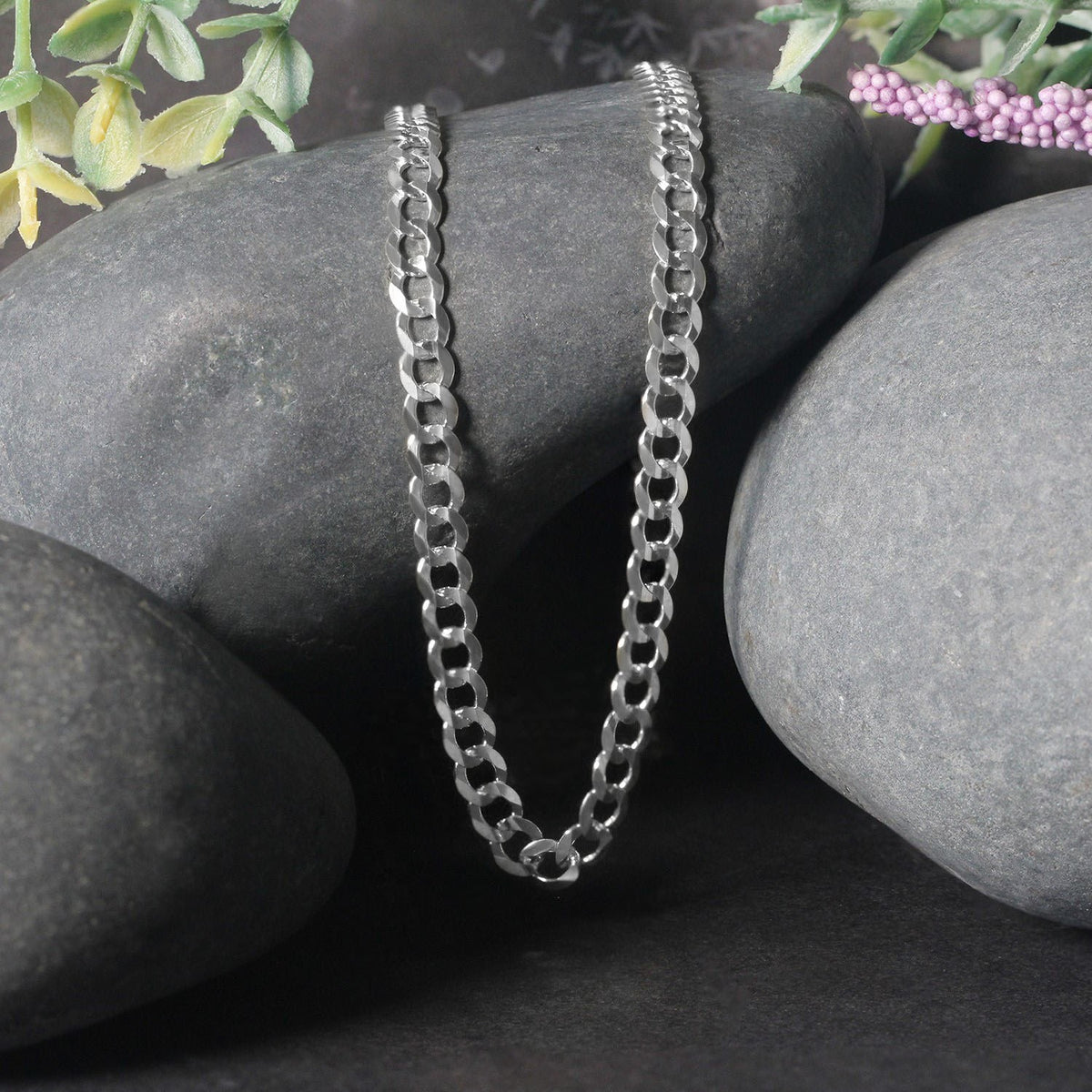 Curb chain in 14K white gold draped over two stones