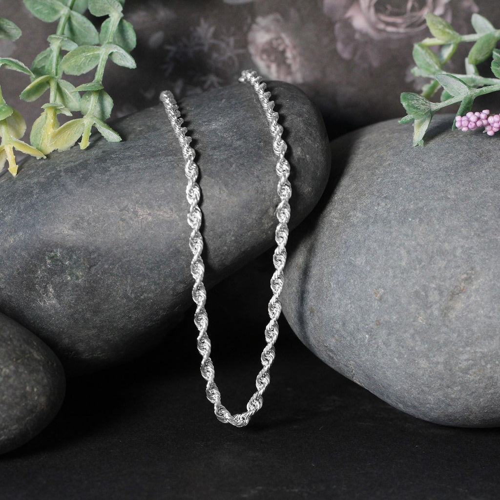 Rope chain in 14K white gold draped over two stones