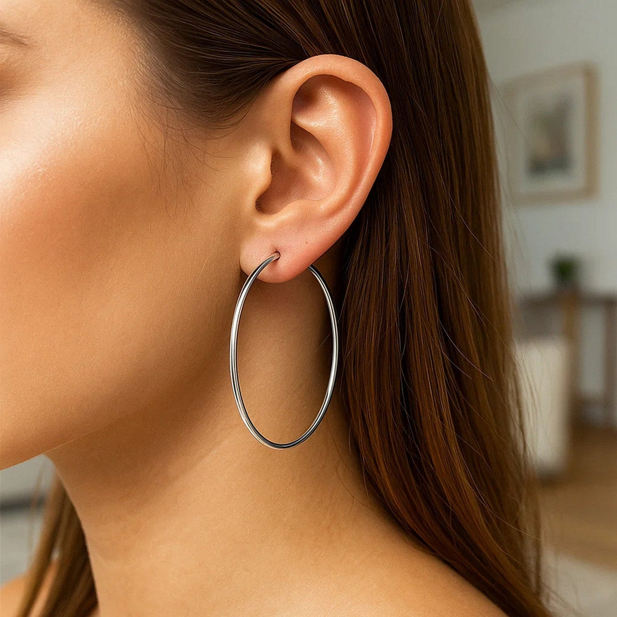 Close-up of a 60mm 14K white gold hoop on the ear