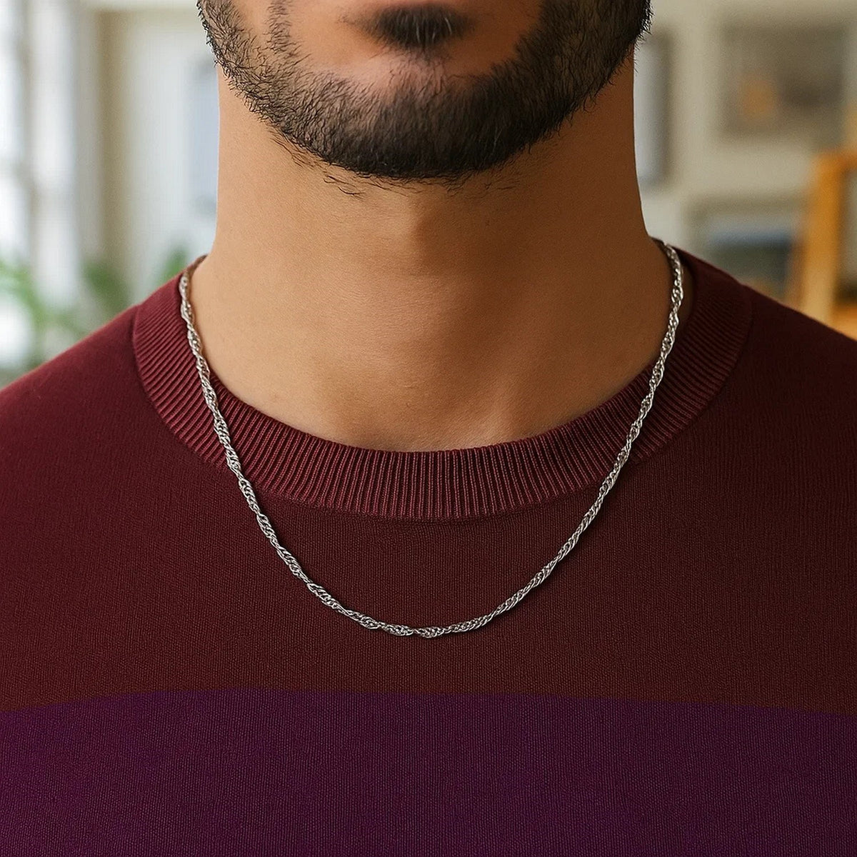 Singapore chain in 14K white gold worn over a dark red top