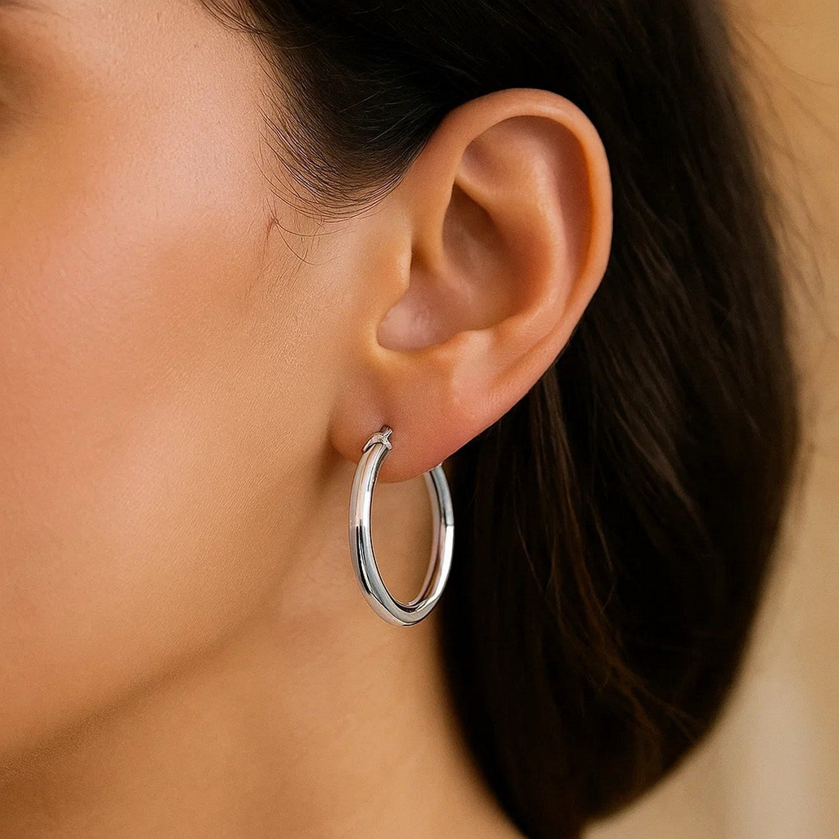 20mm 14K white gold hoop on the ear, side view