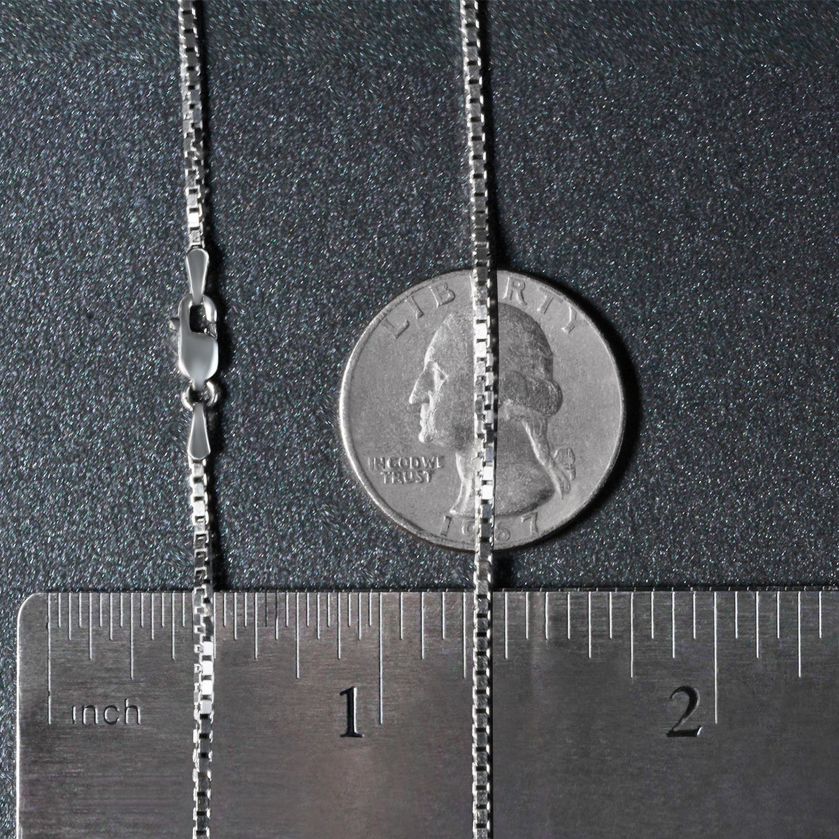 1.4mm box chain in 14K white gold beside an inch ruler and a coin for scale