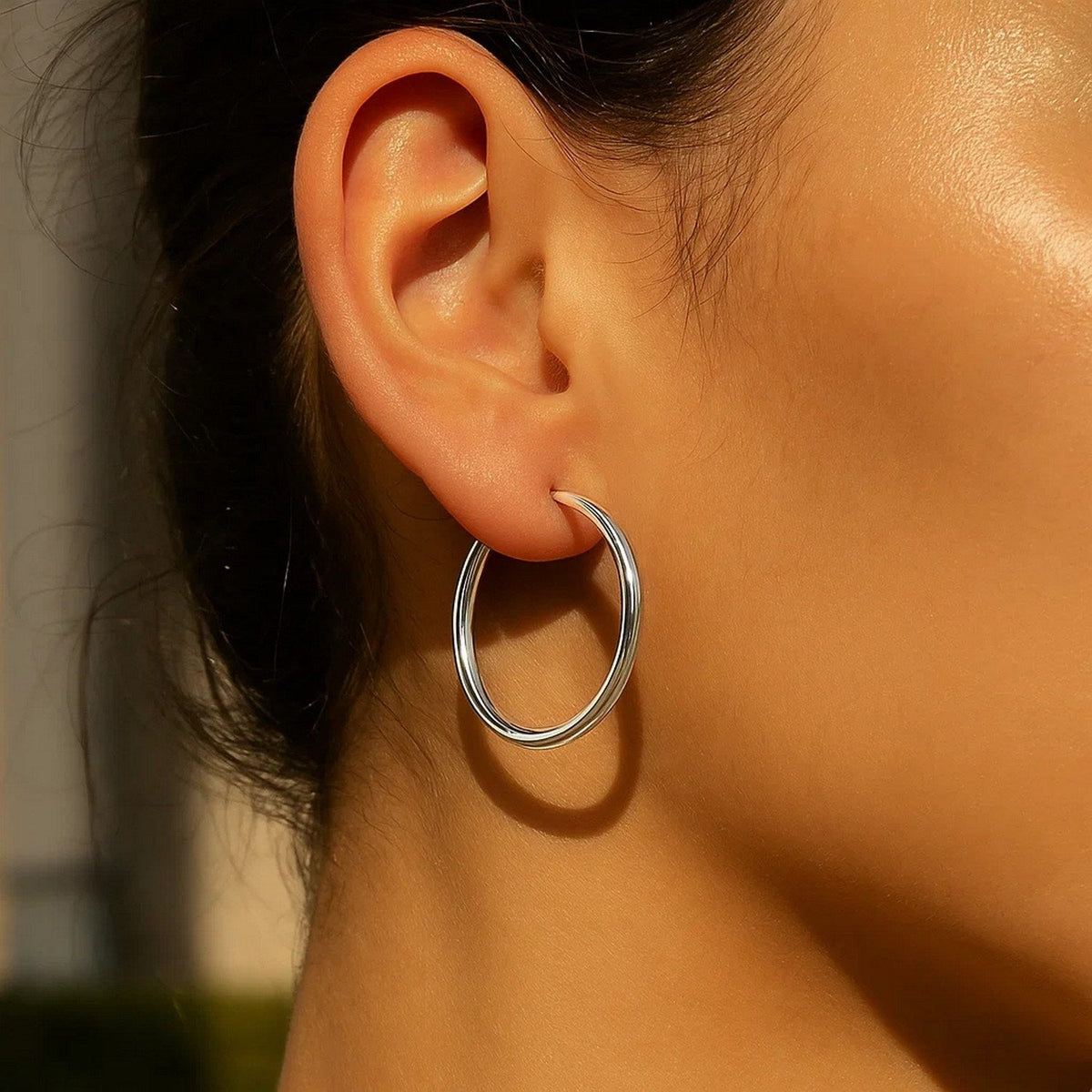 30mm 14K white gold hoop on the ear, side view