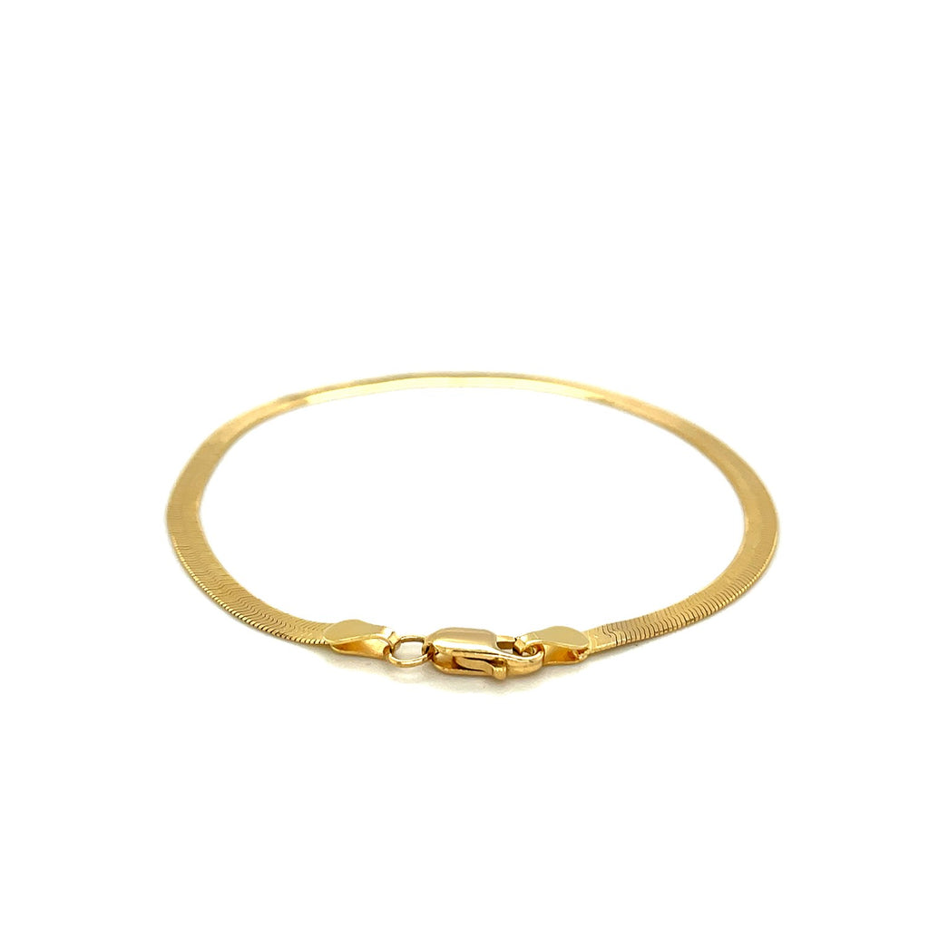 Lobster clasp and flat end caps on the 14K yellow gold herringbone bracelet