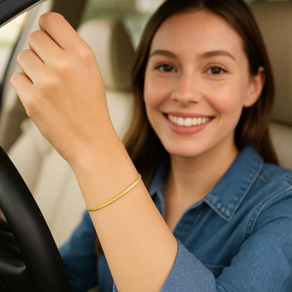 Herringbone bracelet in 14K yellow gold worn while driving