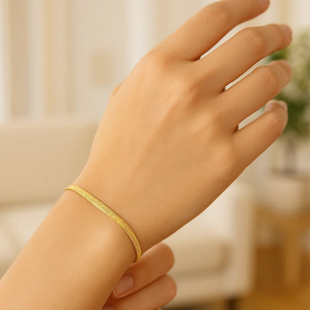 Herringbone bracelet in 14K yellow gold worn on the wrist