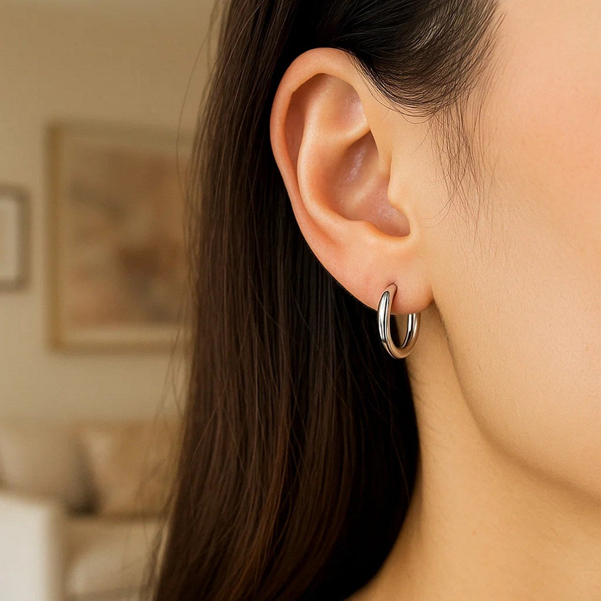 Close-up of a 15mm 14K white gold hoop on the ear