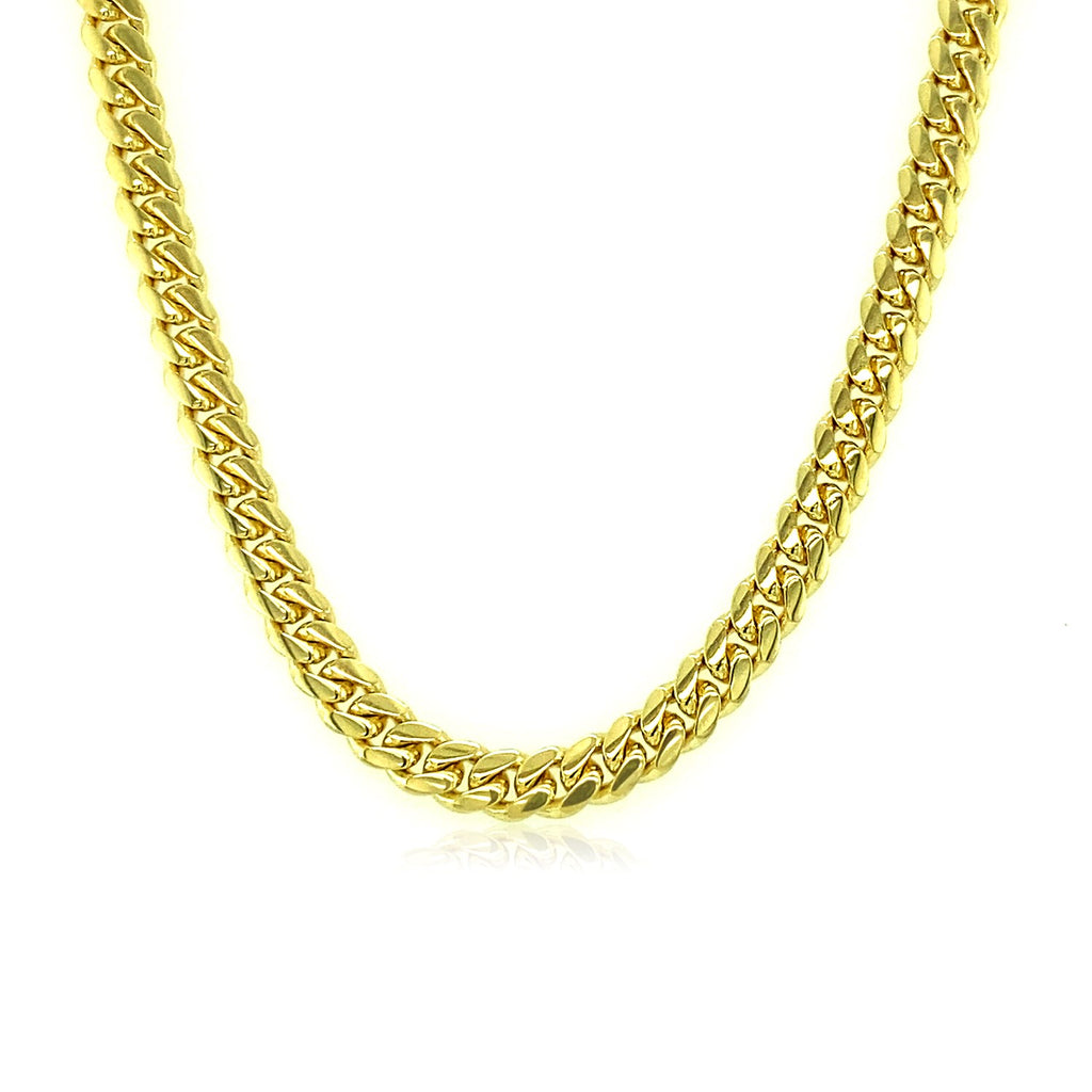 Solid Miami Cuban chain in 14K yellow gold hanging in a curve