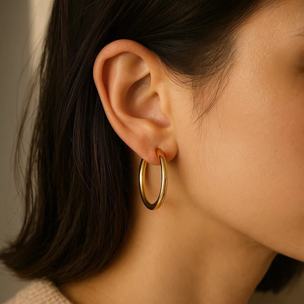 Close-up of a 30mm 14K yellow gold hoop on the ear