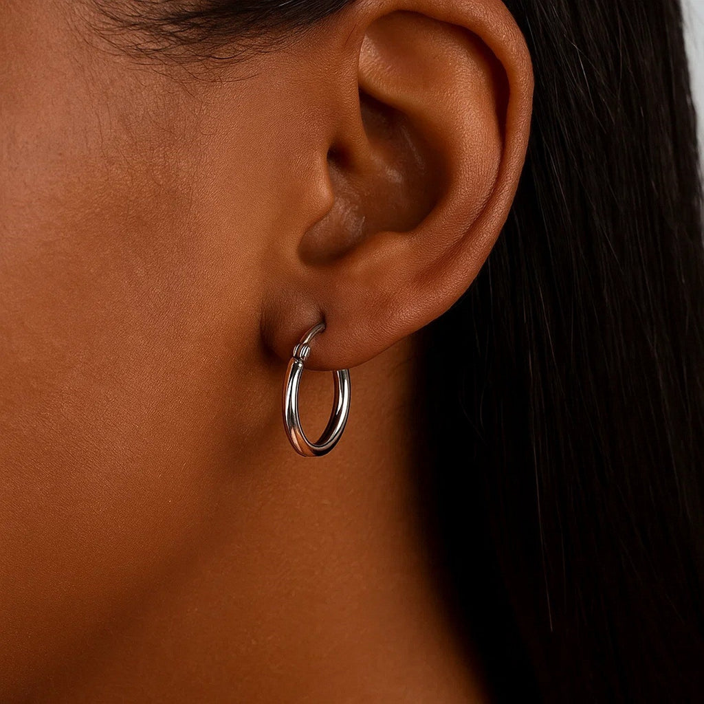 Close-up of a 15mm 14K white gold hoop on the ear