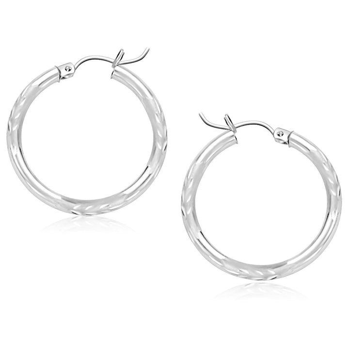 Diamond-cut hoop earrings in 14K white gold, 25mm, showing the faceted surface