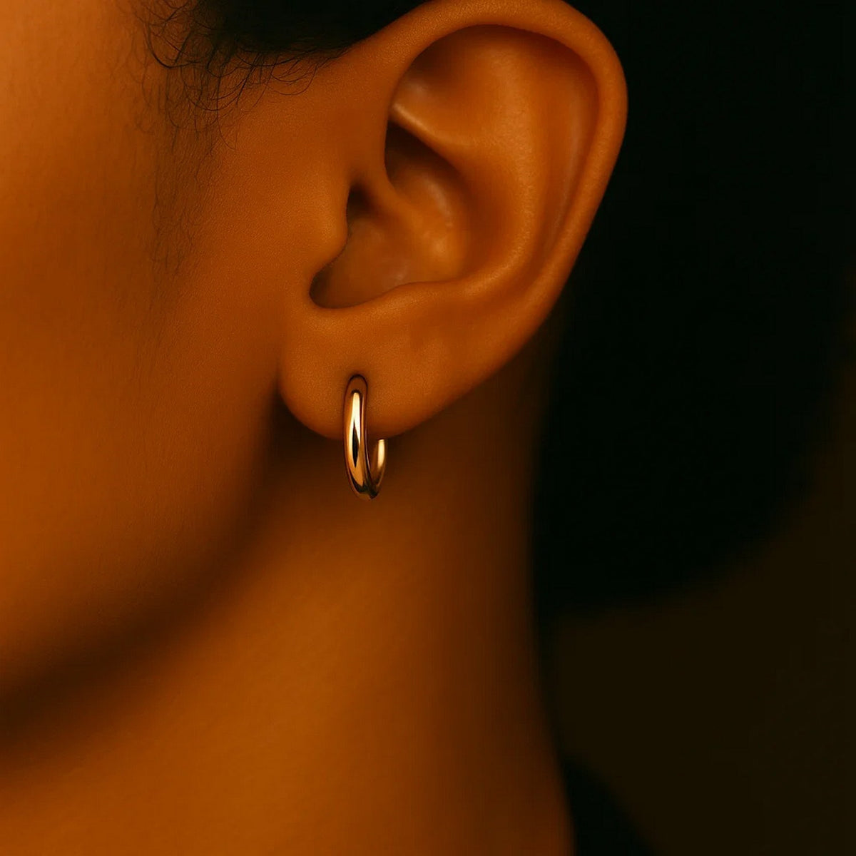 Close-up of a 15mm 14K yellow gold hoop on the ear