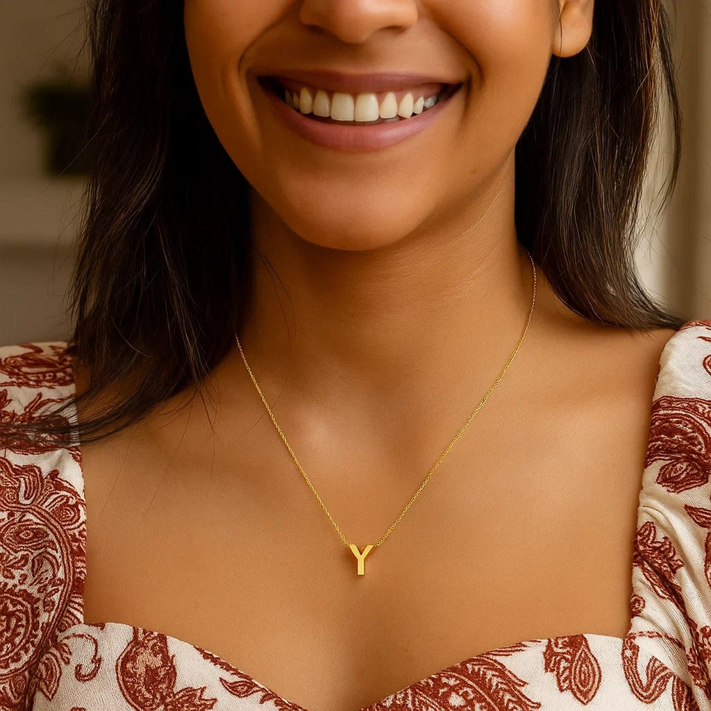 Block letter Y initial necklace in 14K yellow gold worn at the neckline