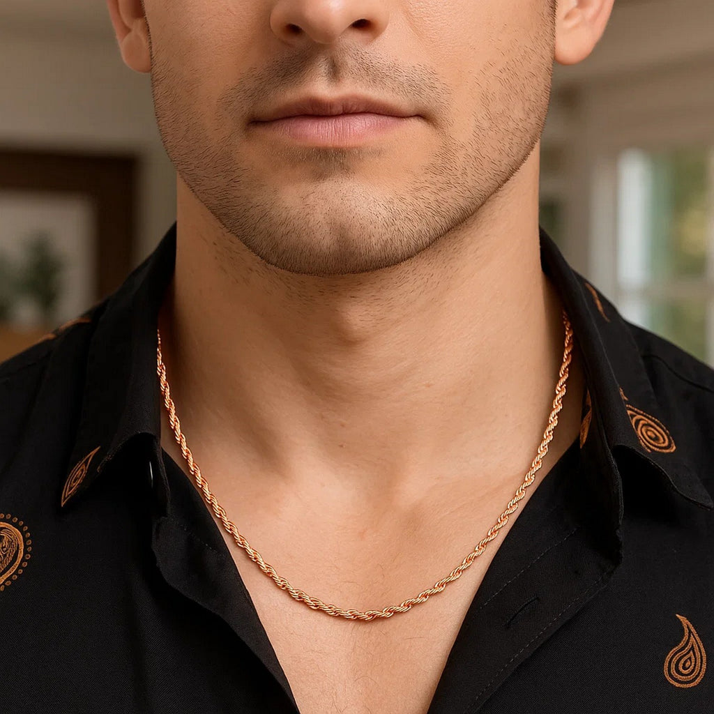 4.00mm rope chain in 14K rose gold worn with a dark open-collared shirt