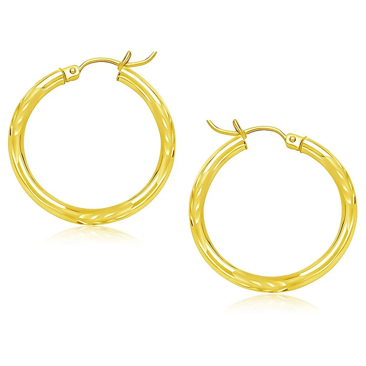 Diamond-cut hoop earrings in 14K yellow gold, 25mm, showing the faceted surface