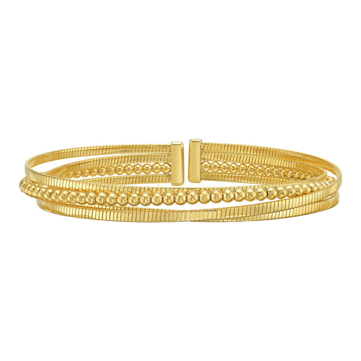 Layered open cuff in 14K yellow gold with ribbed omega strands and a polished bead strand
