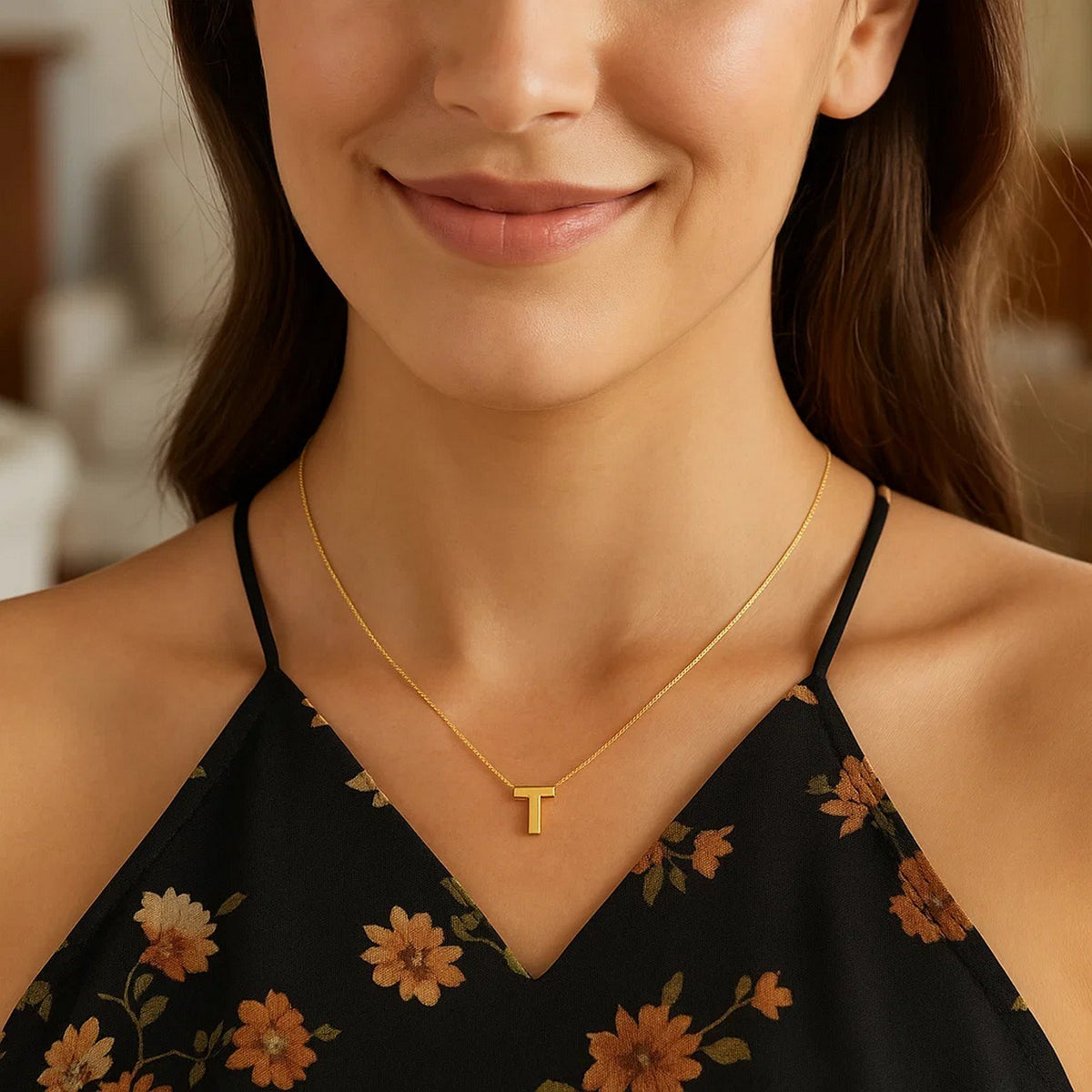 Block letter T initial necklace in 14K yellow gold worn at the neckline