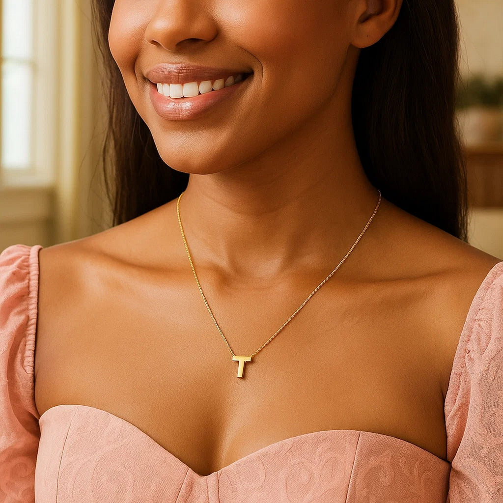 Block letter T initial necklace in 14K yellow gold worn, second view