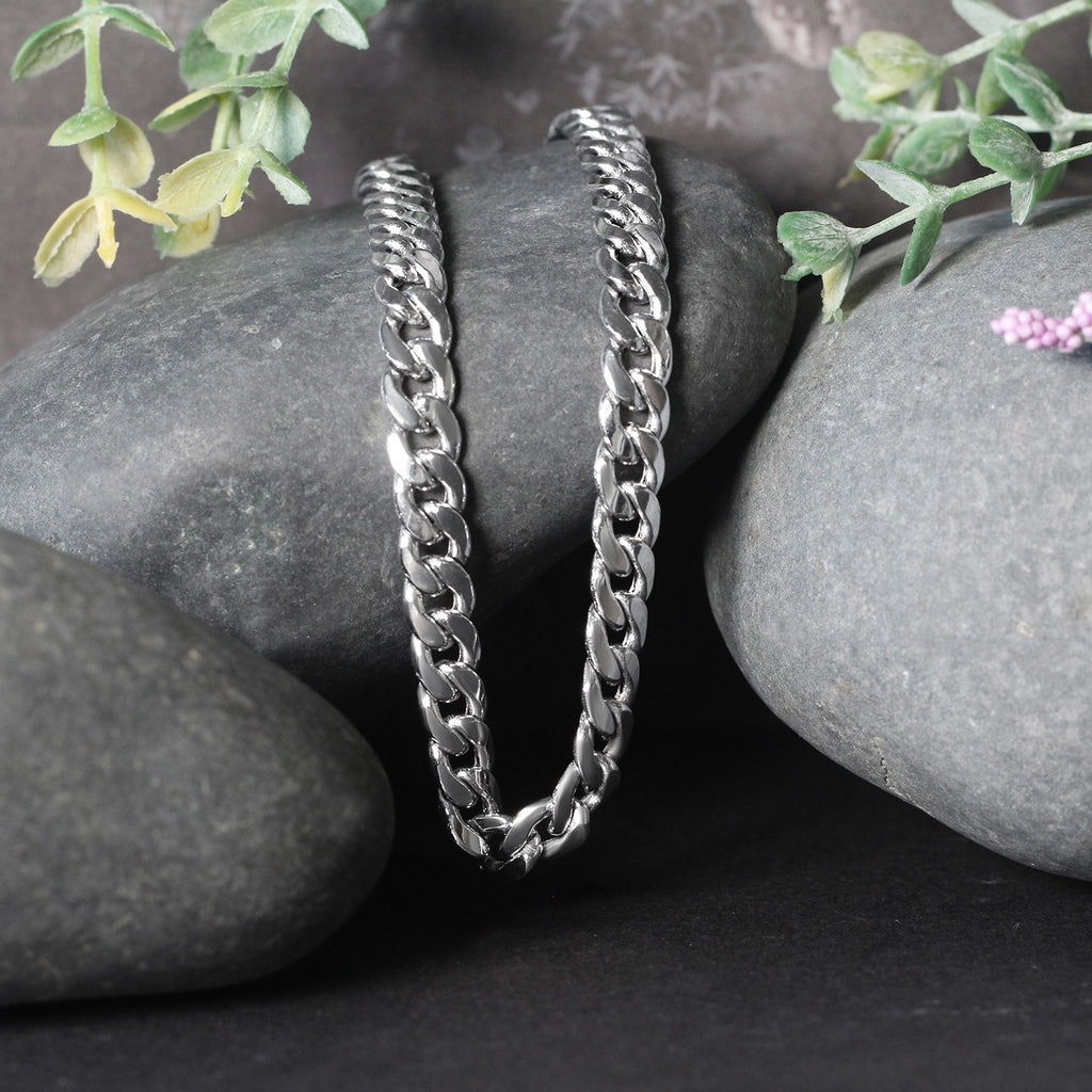Miami Cuban chain in 14K white gold draped over two stones