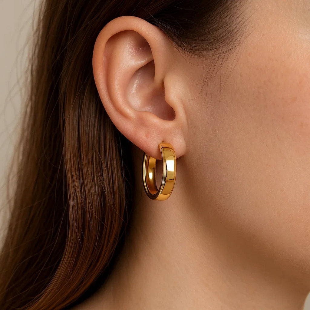 Close-up of a wedding band 14K yellow gold hoop on the ear