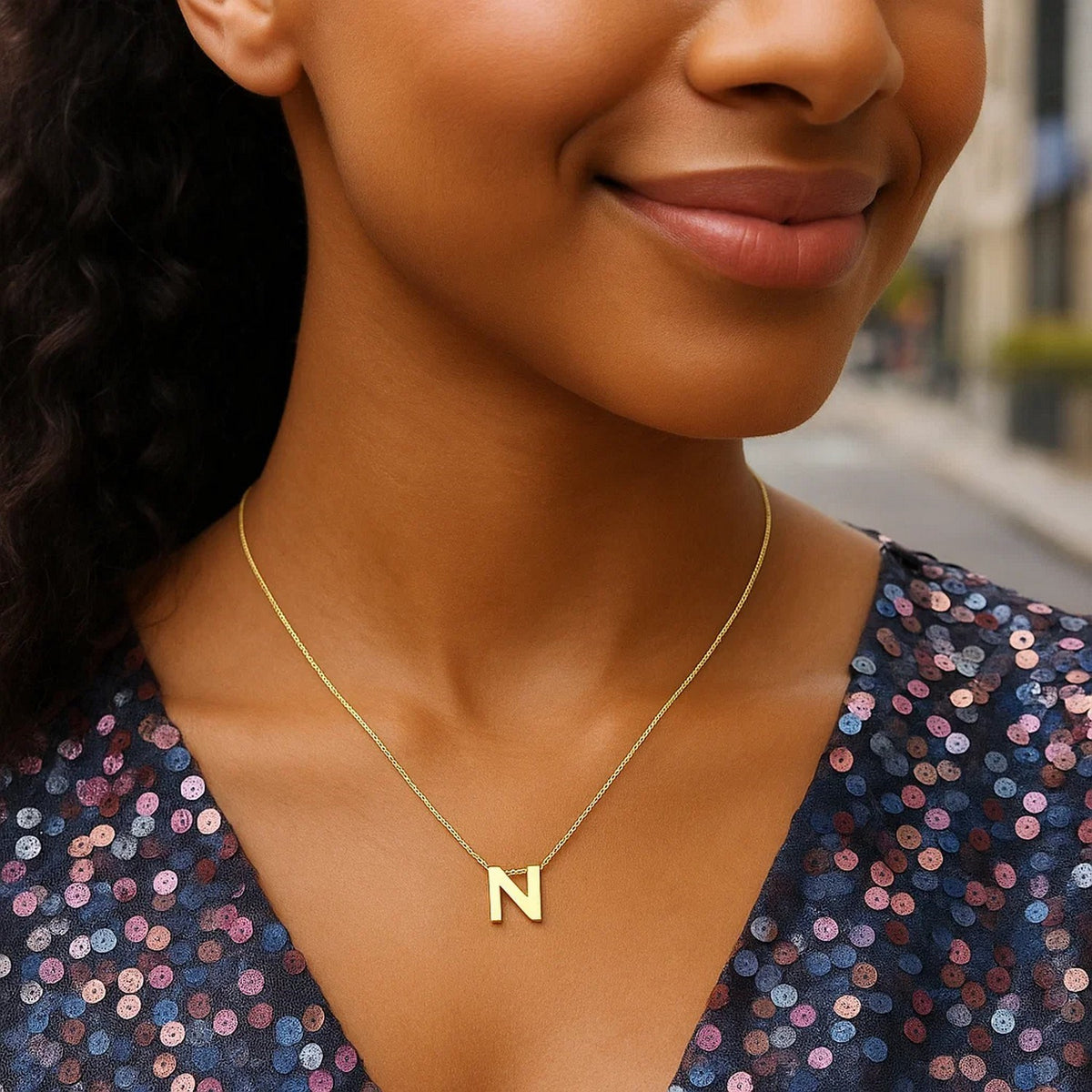 Block letter N initial necklace in 14K yellow gold worn, second view