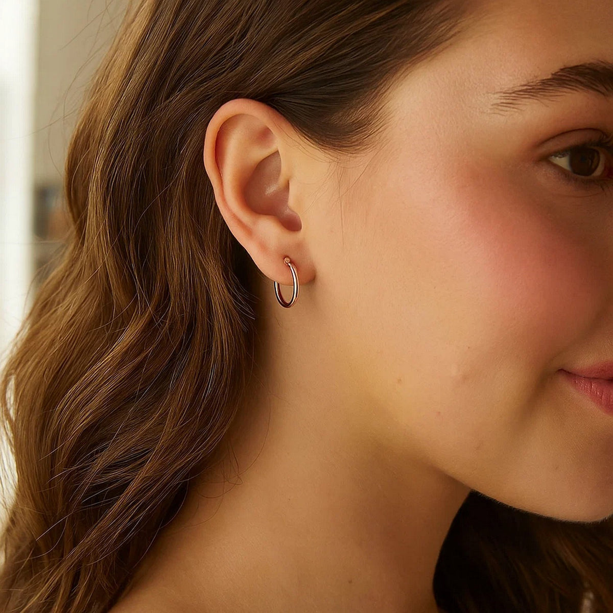15mm 14K rose gold hoop worn on the ear