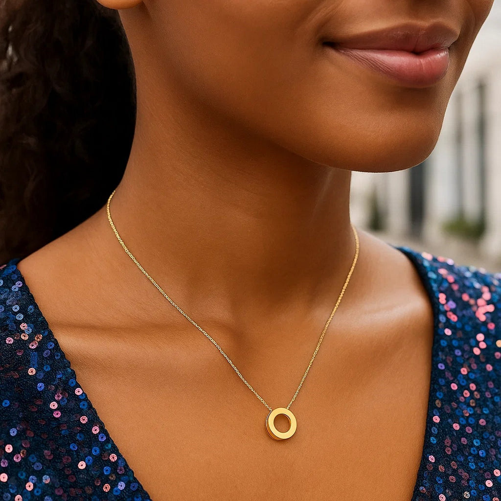 Block letter O initial necklace in 14K yellow gold worn at the neckline