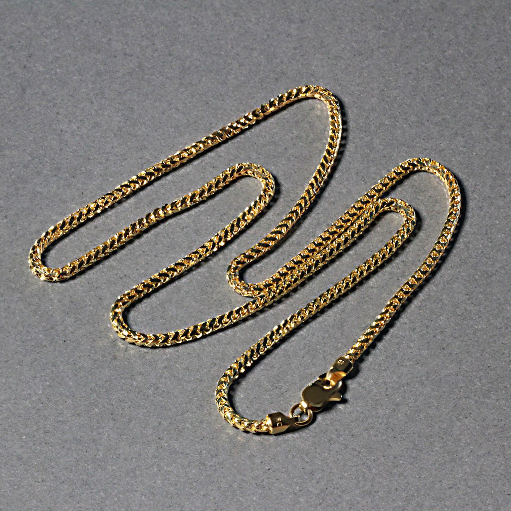 Diamond-cut Franco chain in 14K yellow gold laid out in loops
