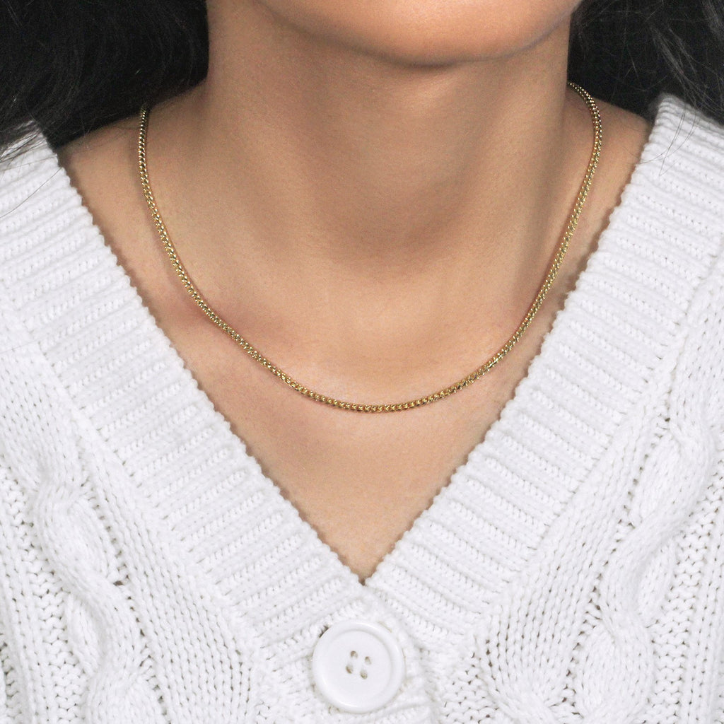2.20mm Franco chain in 14K yellow gold worn with a white cable-knit cardigan