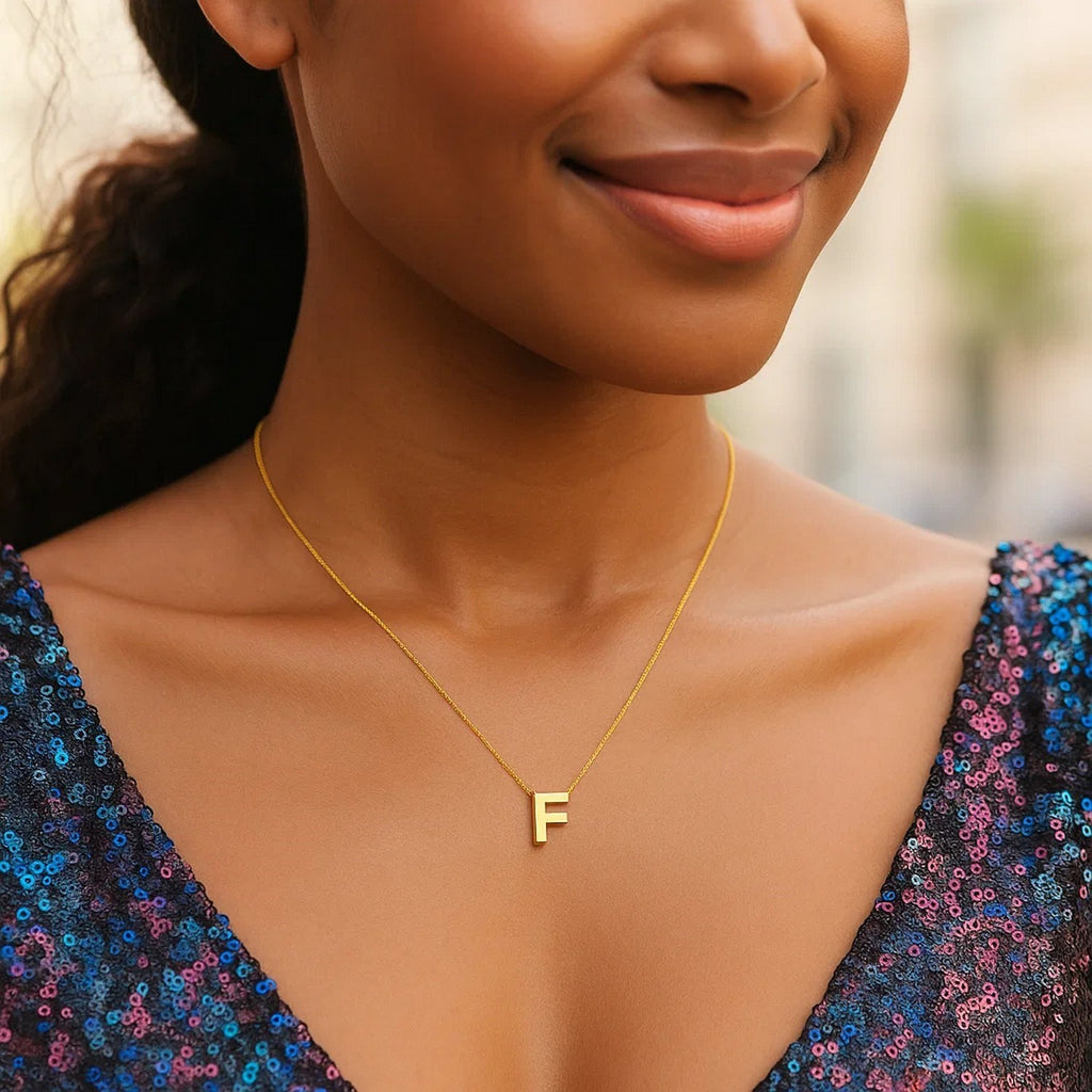 Block letter F initial necklace in 14K yellow gold worn, second view