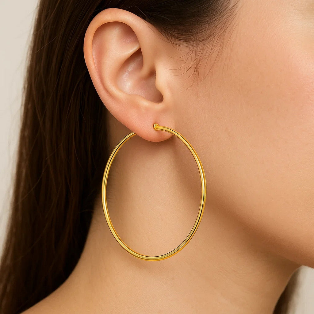 Close-up of a 60mm 14K yellow gold hoop on the ear, showing its size