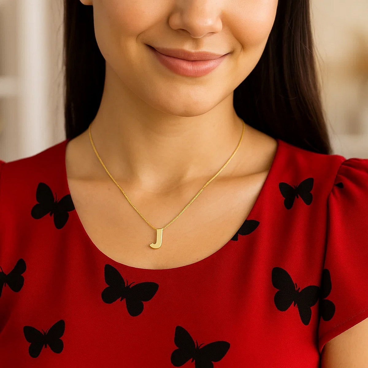 Block letter J initial necklace in 14K yellow gold worn, second view