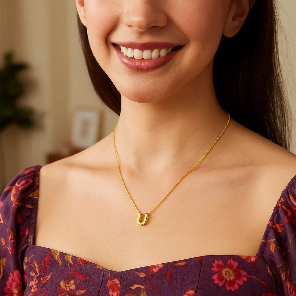 Block letter U initial necklace in 14K yellow gold worn, second view