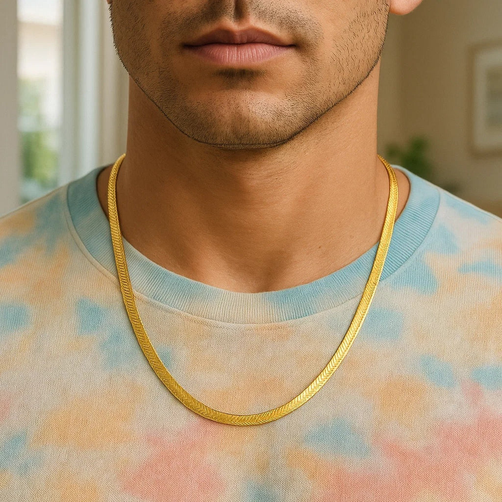 6.00mm herringbone chain in 14K yellow gold worn over a tie-dye T-shirt