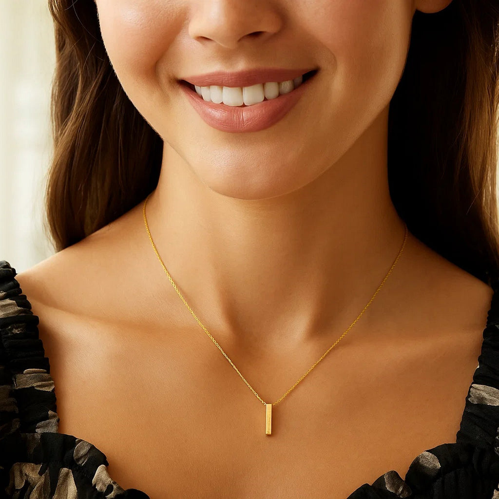 Block letter I initial necklace in 14K yellow gold worn at the neckline