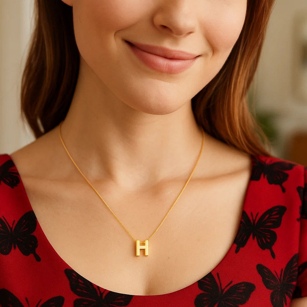 Block letter H initial necklace in 14K yellow gold worn, second view