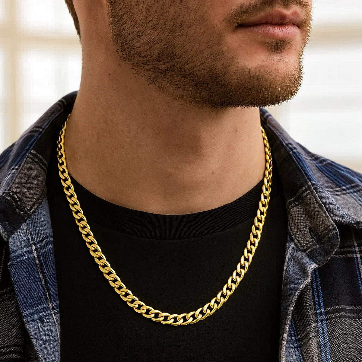 7.00mm Miami Cuban chain in 14K yellow gold worn over a T-shirt and open shirt