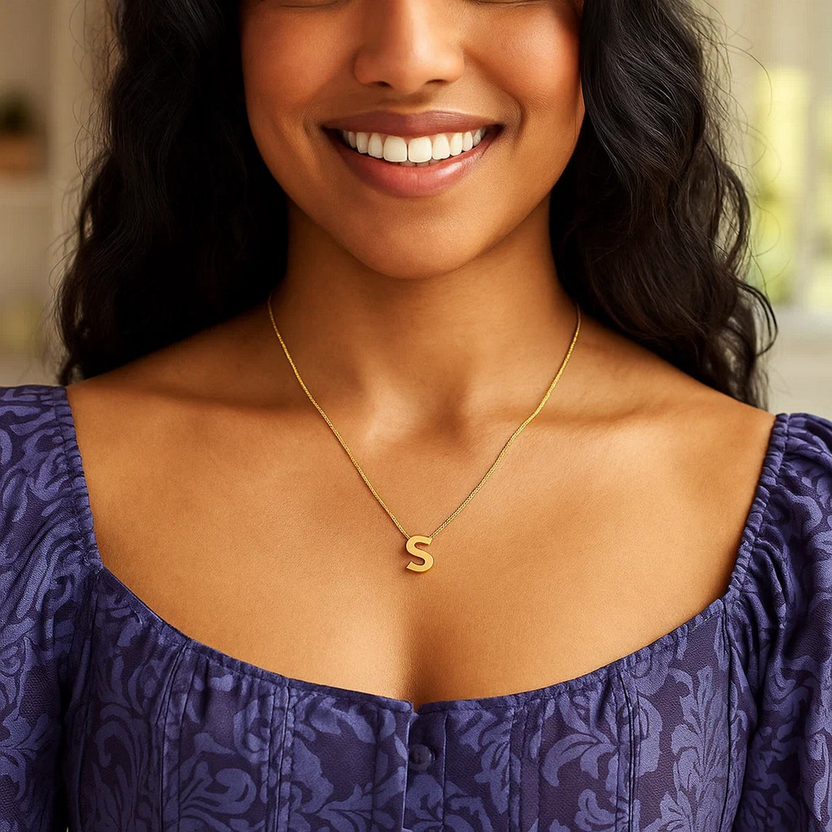 Block letter S initial necklace in 14K yellow gold worn, second view