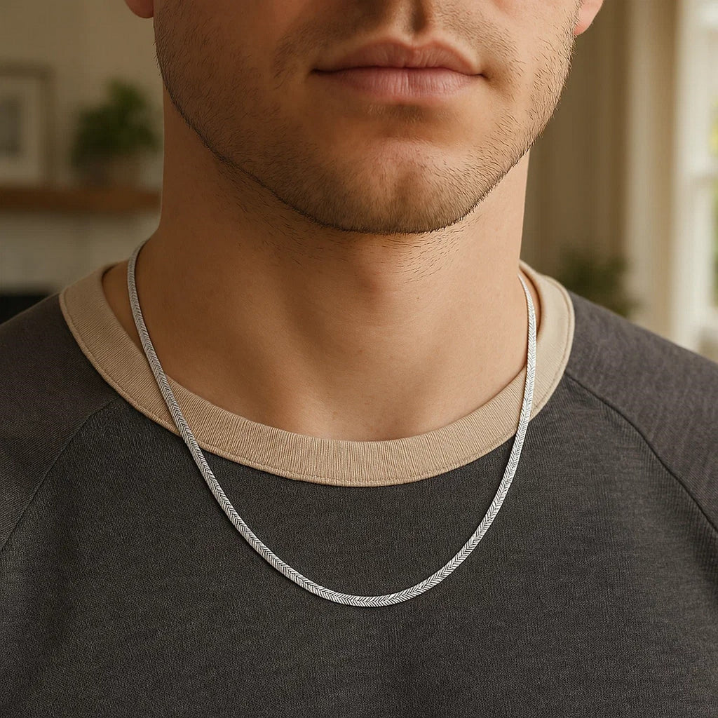 2.80mm herringbone chain in 14K white gold worn over a dark T-shirt